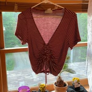 Maroon and white stripped shirt with tie in front.